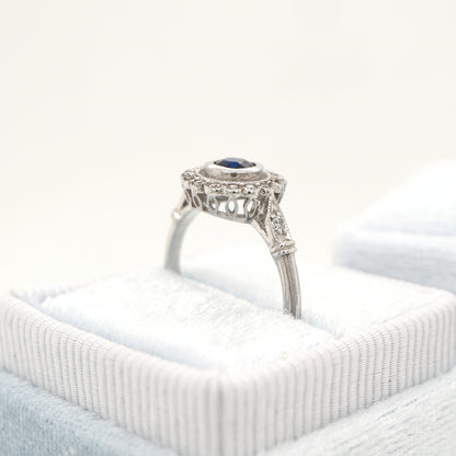 Laboratory grown blue sapphire with CZ halo in sterling silver ring