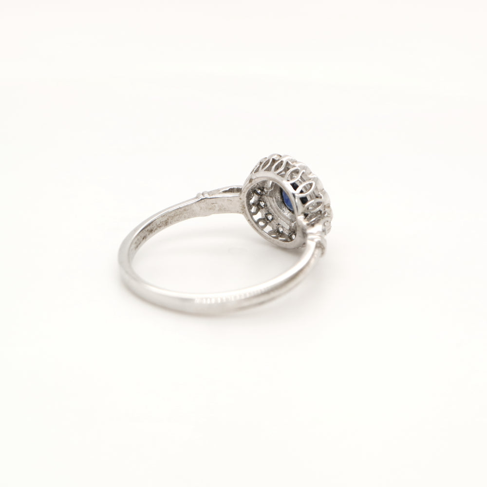 Laboratory grown blue sapphire with CZ halo in sterling silver ring