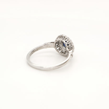 Laboratory grown blue sapphire with CZ halo in sterling silver ring