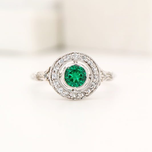 Laboratory grown emerald with CZ halo ring in sterling silver