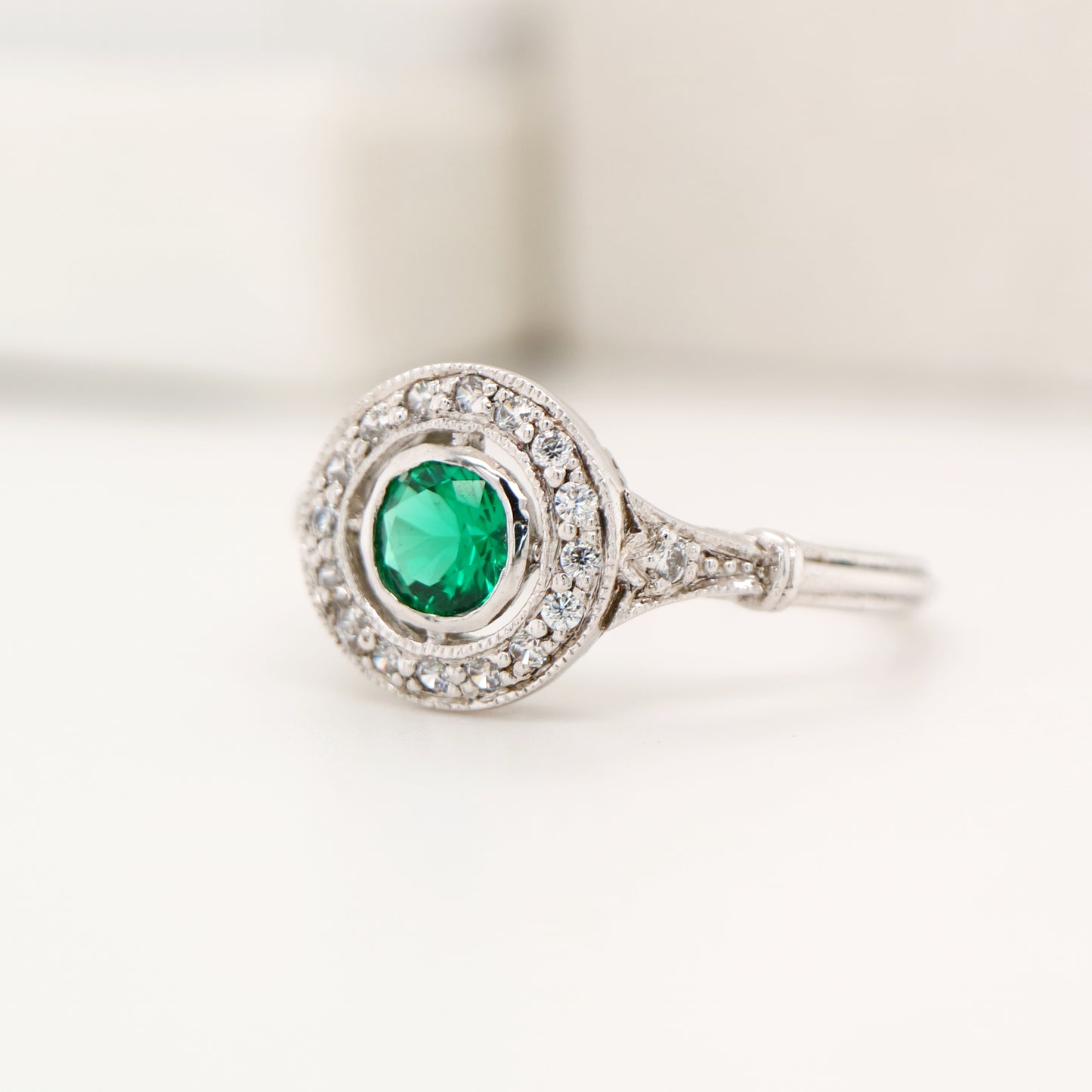 Laboratory grown emerald with CZ halo ring in sterling silver