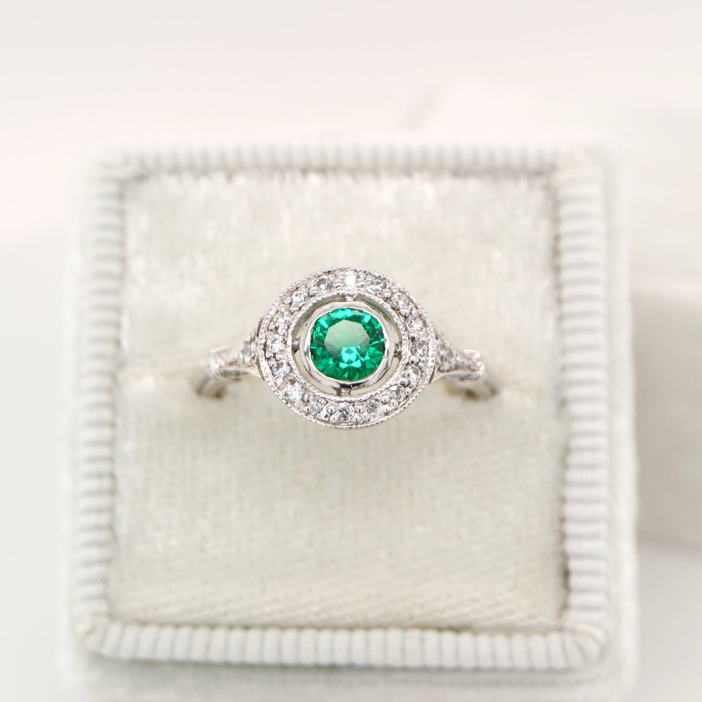 Laboratory grown emerald with CZ halo ring in sterling silver