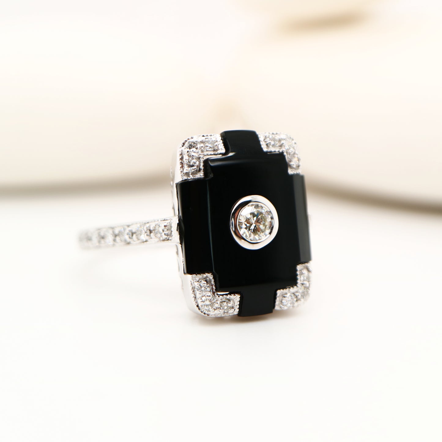 Art deco step cut ring with onyx and diamond in white gold