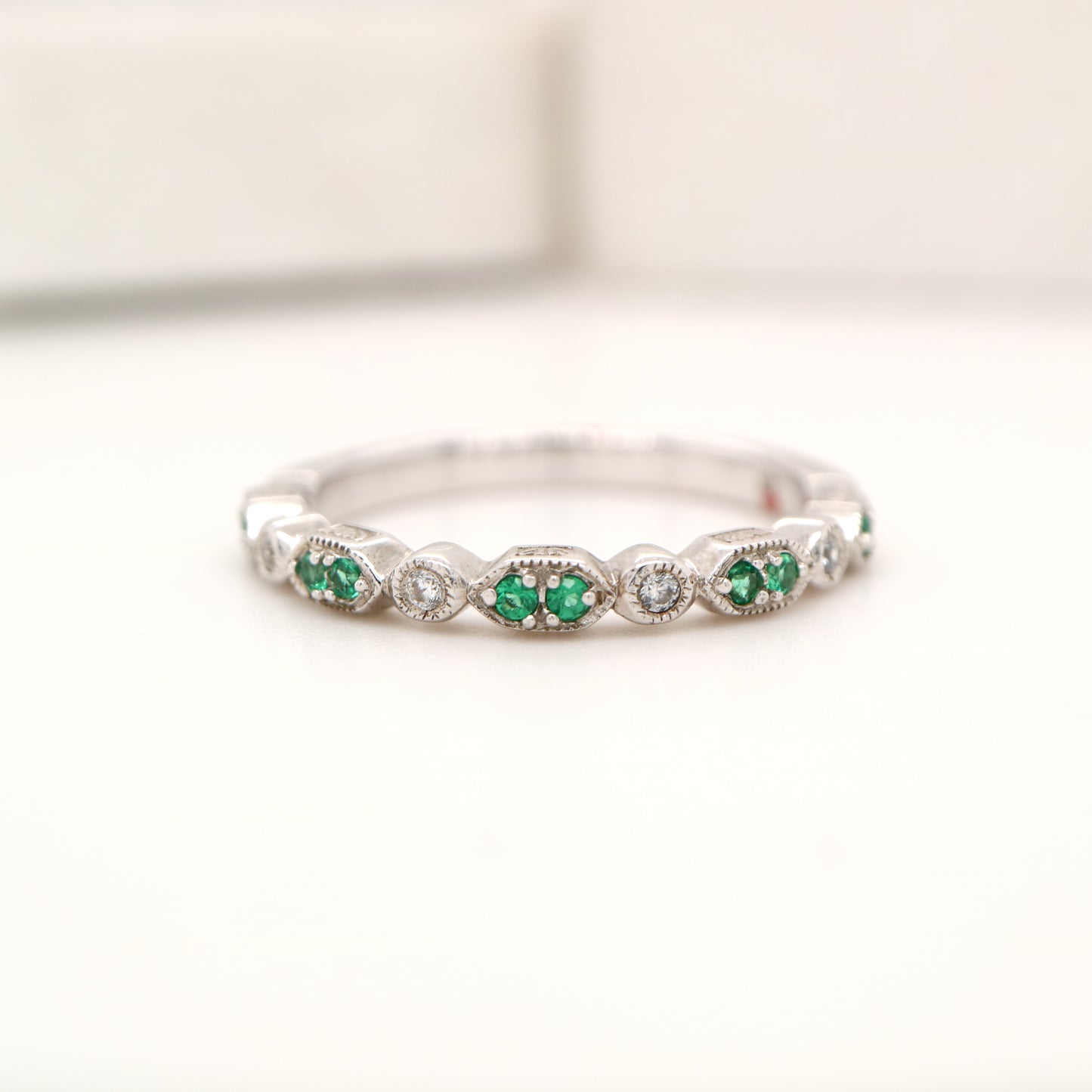 White gold, double emerald and diamond celebration band