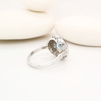 Round blue topaz ring with onyx and diamond halo in 9k white gold