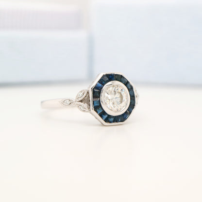 Target ring with channel set sapphires and moissanite in white gold