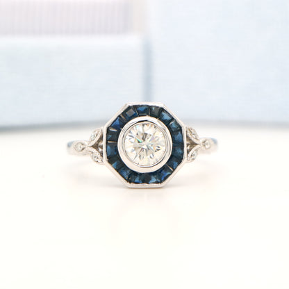 Target ring with channel set sapphires and moissanite in white gold