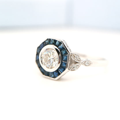 Target ring with channel set sapphires and moissanite in white gold