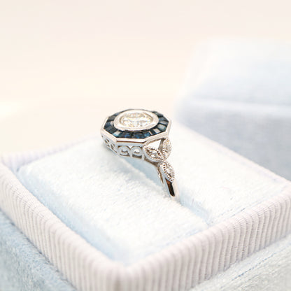 Target ring with channel set sapphires and moissanite in white gold