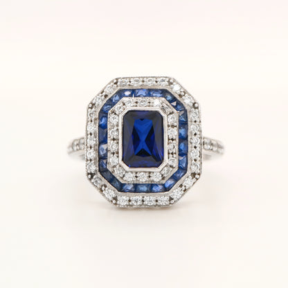 Sapphire cocktail ring with gemstone stripe halo's