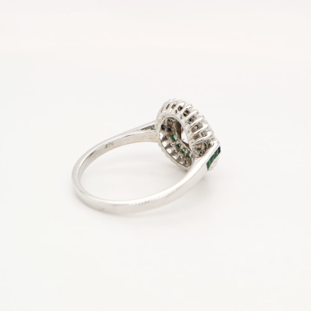 Moissanite and emerald target ring with sapphire accents in white gold