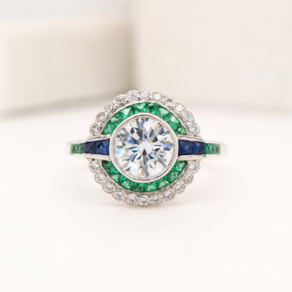 Moissanite and emerald target ring with sapphire accents in white gold