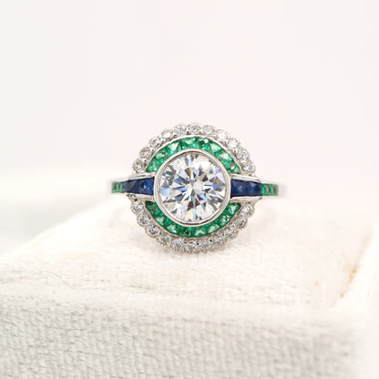 Moissanite and emerald target ring with sapphire accents in white gold