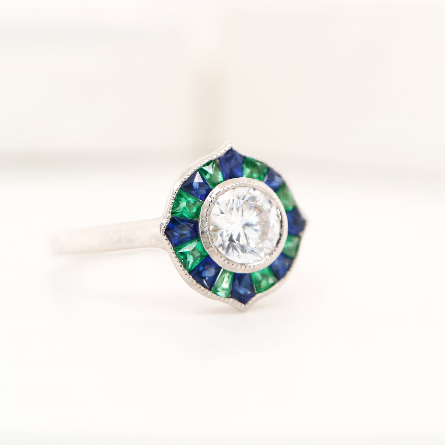 Diamond, emerald and sapphire target ring in white gold