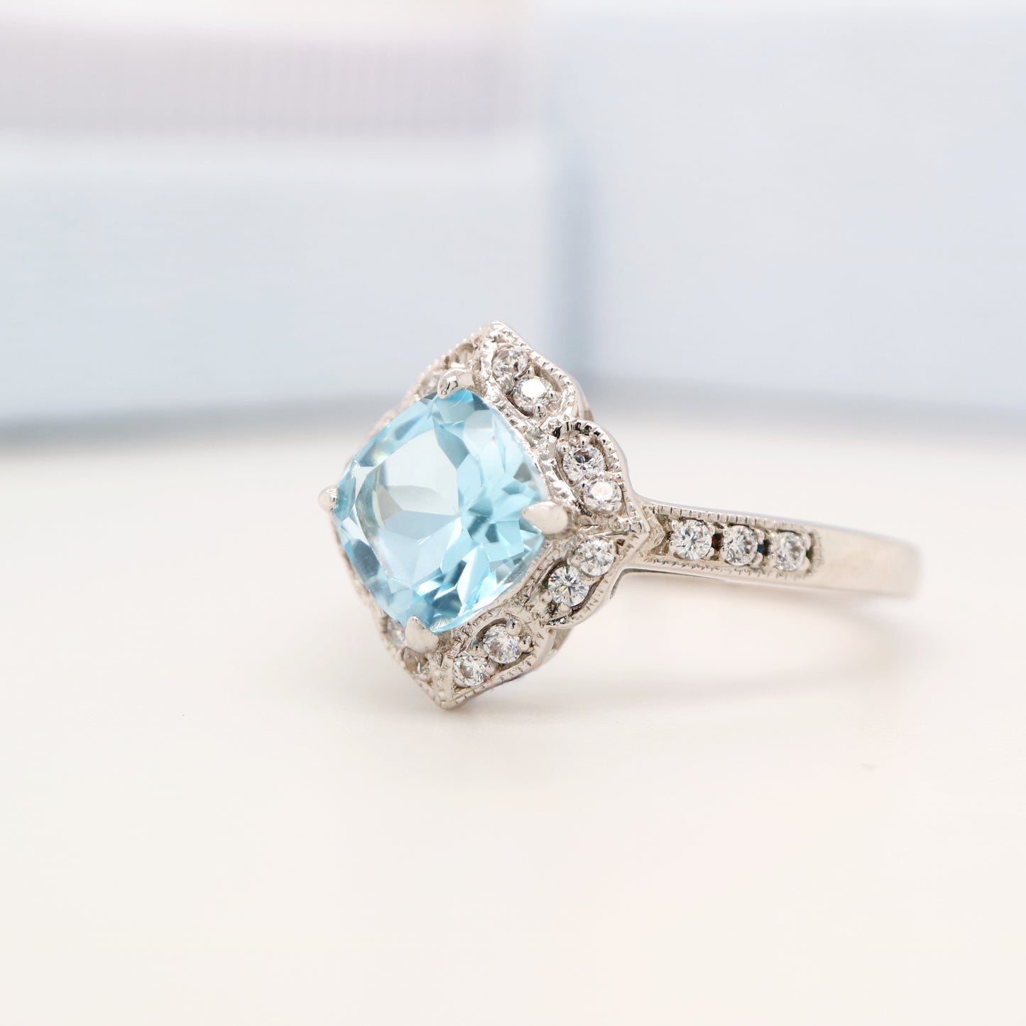 Aquamarine in 9k white gold with diamond halo