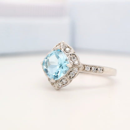 Aquamarine in 9k white gold with diamond halo