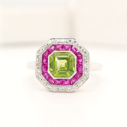 Peridot target ring with ruby and diamond halo in white gold