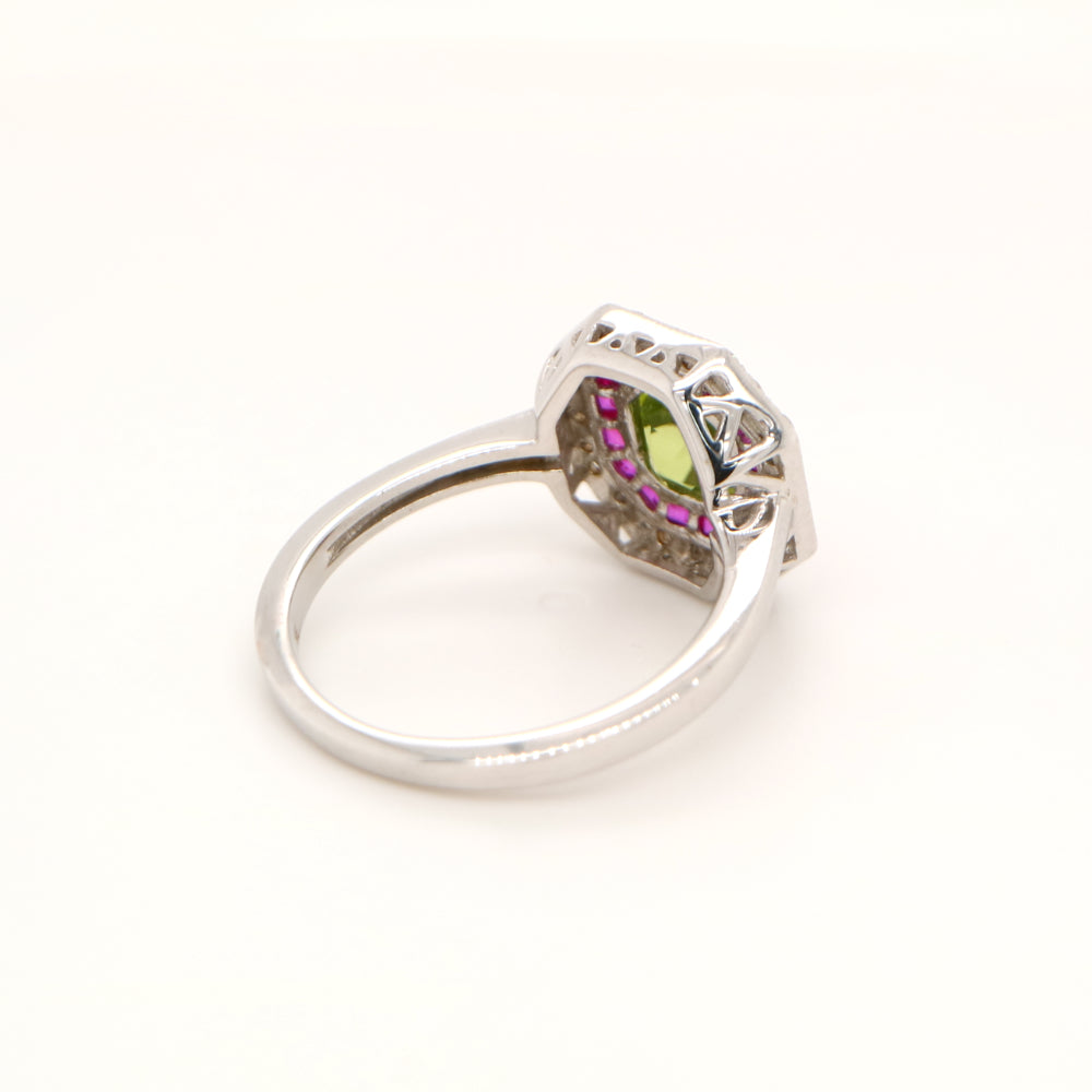 Peridot target ring with ruby and diamond halo in white gold
