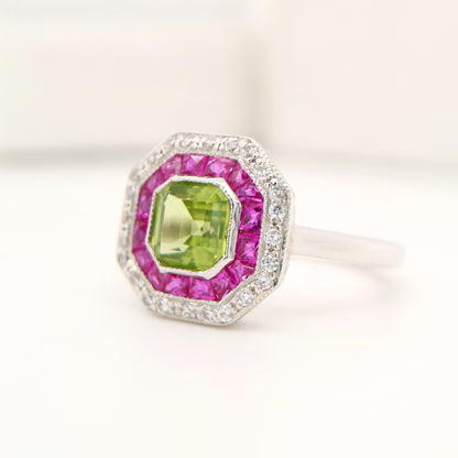 Peridot target ring with ruby and diamond halo in white gold