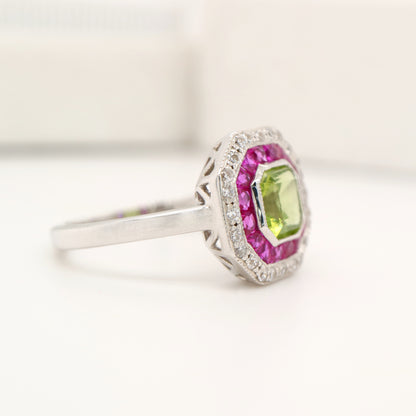 Peridot target ring with ruby and diamond halo in white gold