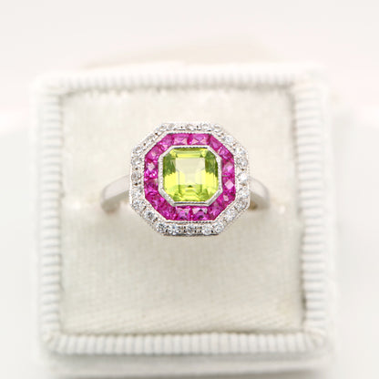 Peridot target ring with ruby and diamond halo in white gold