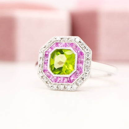 Peridot target ring with pink sapphires and diamond halo in white gold