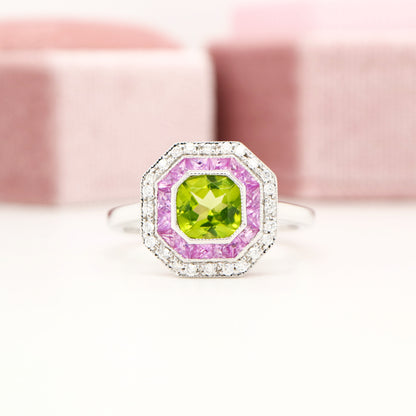 Peridot target ring with pink sapphires and diamond halo in white gold