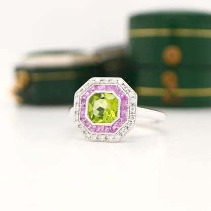 Peridot target ring with pink sapphires and diamond halo in white gold