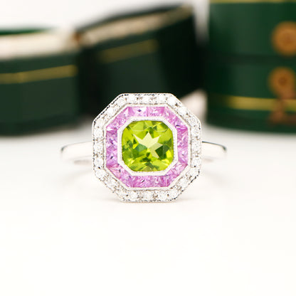 Peridot target ring with pink sapphires and diamond halo in white gold