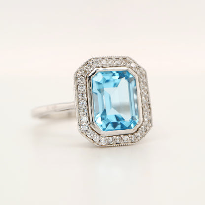 Blue topaz with diamond halo in white gold ring