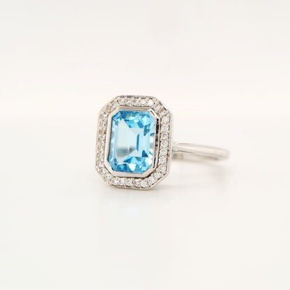 Blue topaz with diamond halo in white gold ring