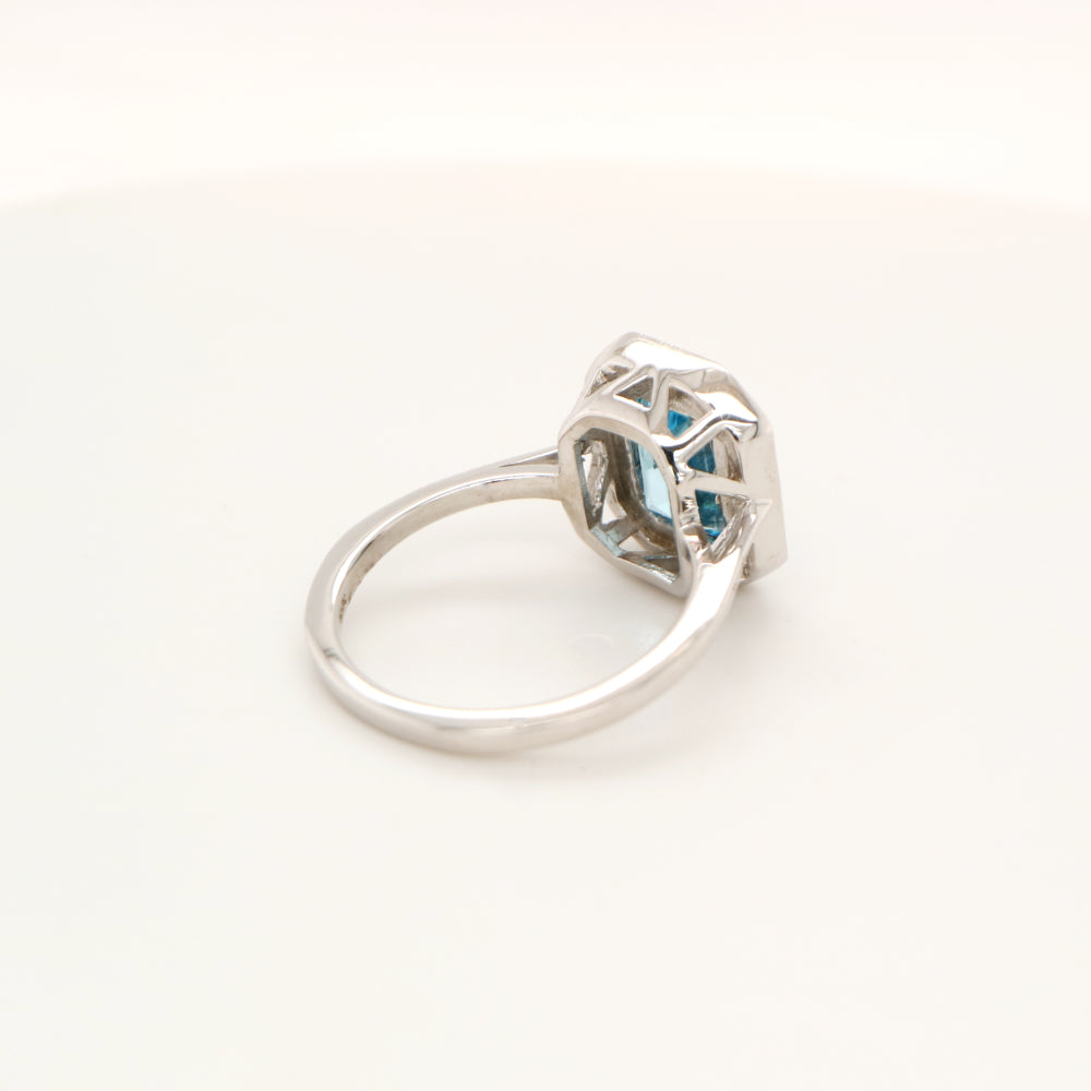 Blue topaz with diamond halo in white gold ring
