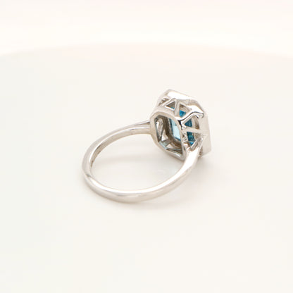 Blue topaz with diamond halo in white gold ring