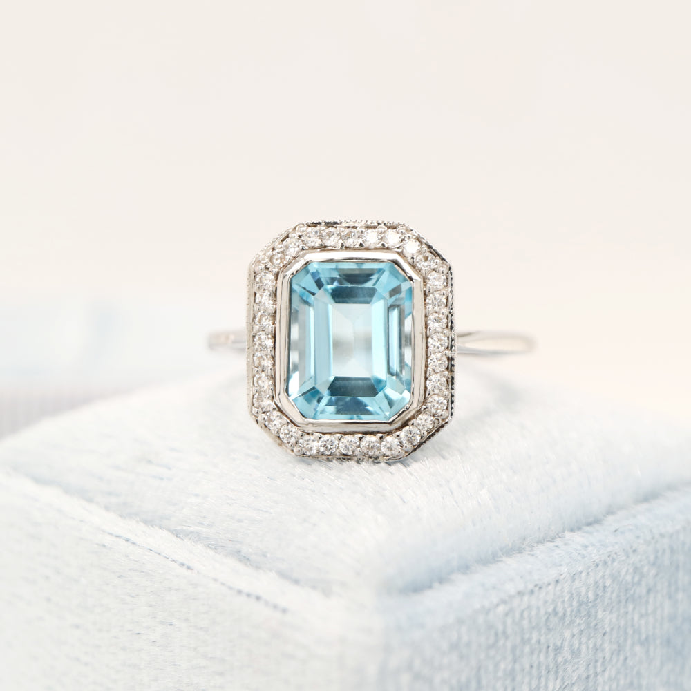 Blue topaz with diamond halo in white gold ring