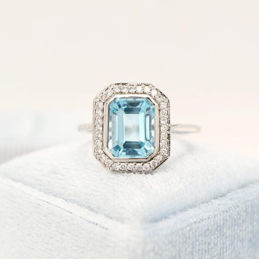 Blue topaz with diamond halo in white gold ring