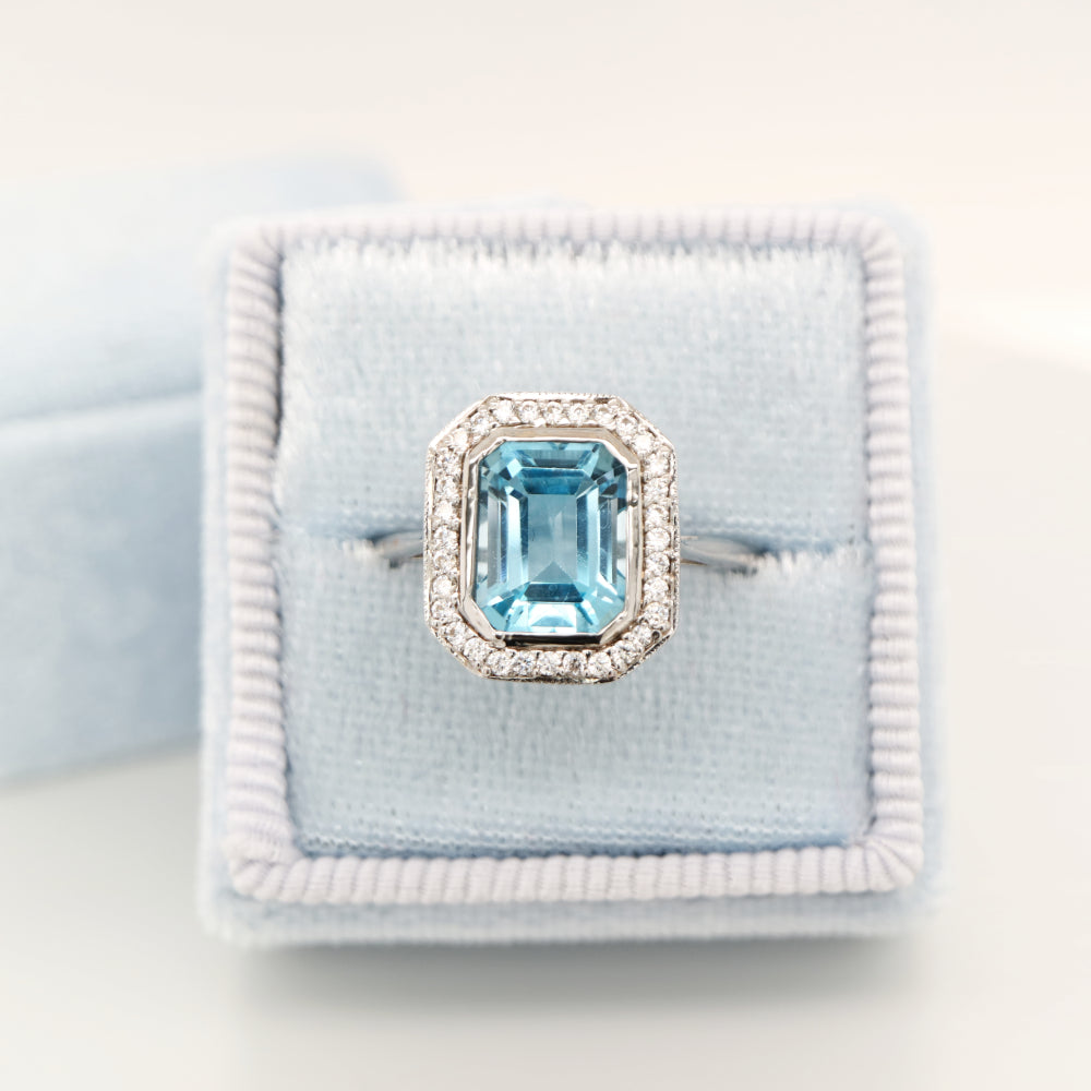 Blue topaz with diamond halo in white gold ring
