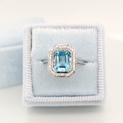 Blue topaz with diamond halo in white gold ring