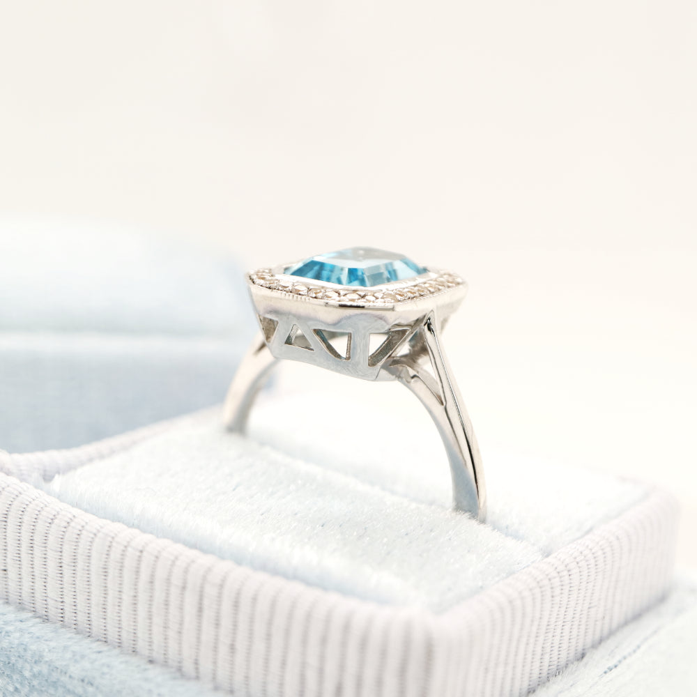 Blue topaz with diamond halo in white gold ring