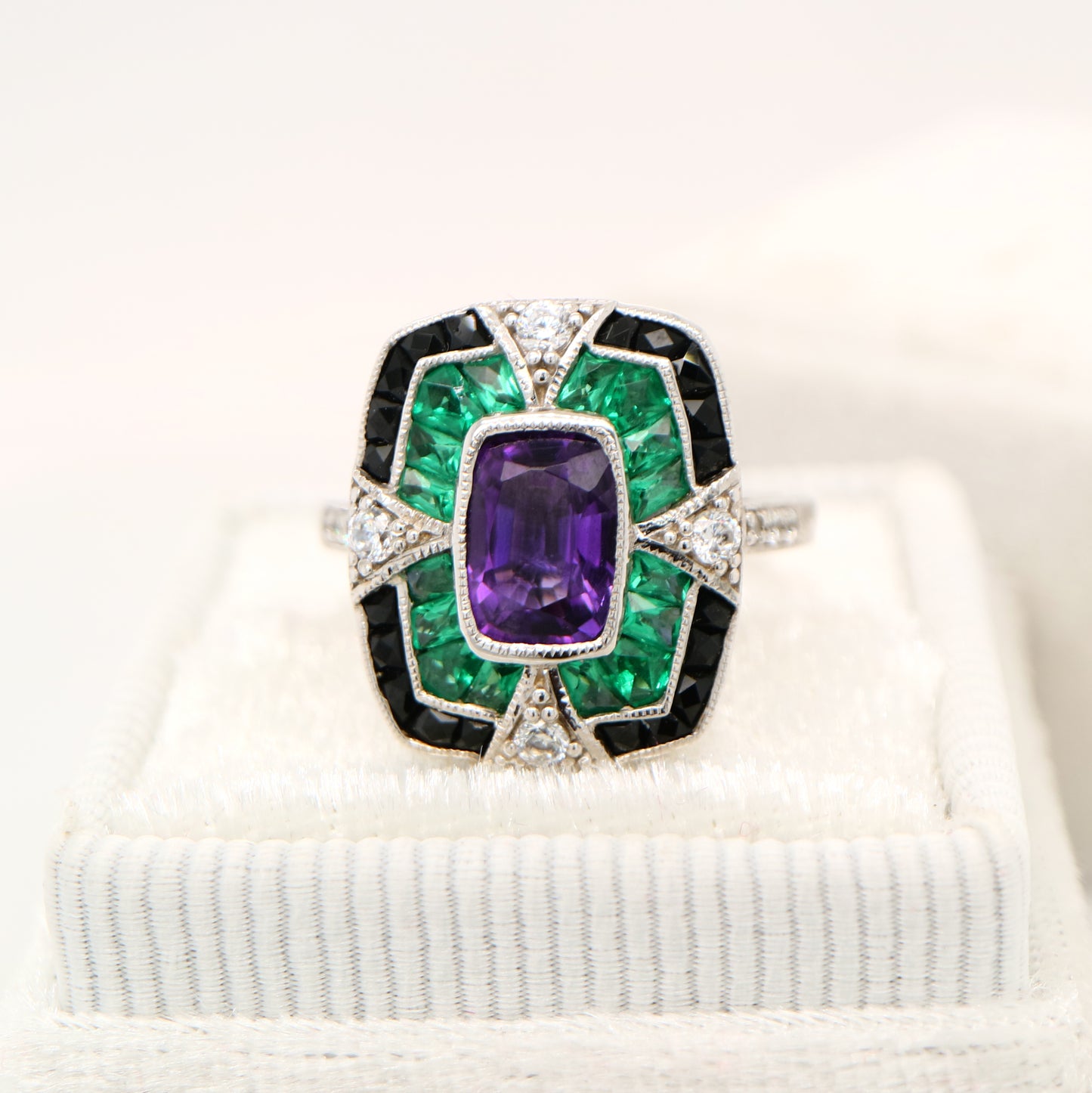 Amethyst cocktail target ring with emerald and onyx halo's in white gold