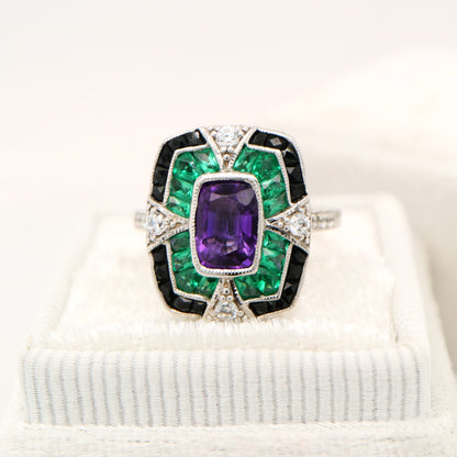 Amethyst cocktail target ring with emerald and onyx halo's in white gold