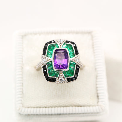 Amethyst cocktail target ring with emerald and onyx halo's in white gold