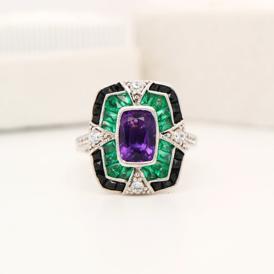Amethyst cocktail target ring with emerald and onyx halo's in white gold