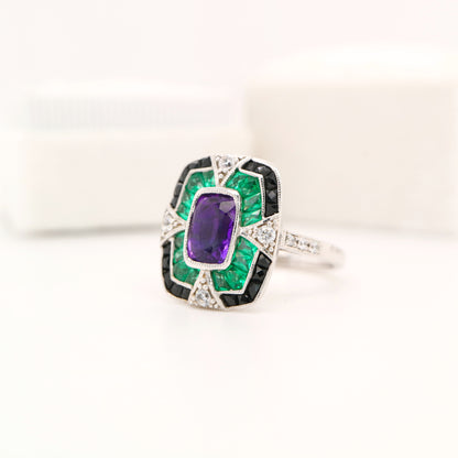 Amethyst cocktail target ring with emerald and onyx halo's in white gold