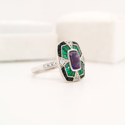 Amethyst cocktail target ring with emerald and onyx halo's in white gold