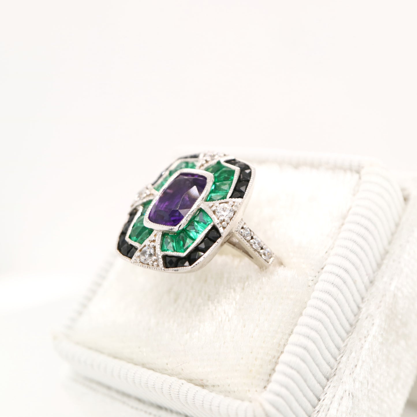 Amethyst cocktail target ring with emerald and onyx halo's in white gold