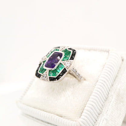 Amethyst cocktail target ring with emerald and onyx halo's in white gold