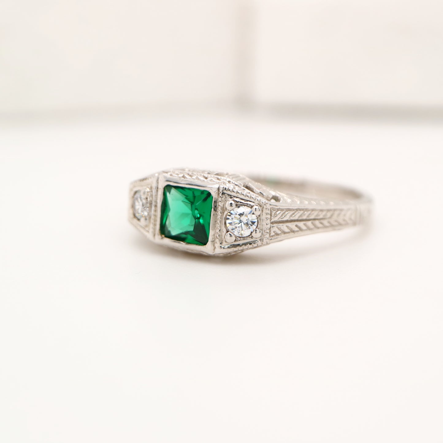 Art deco 9k white gold ring with center emerald and shoulder diamonds