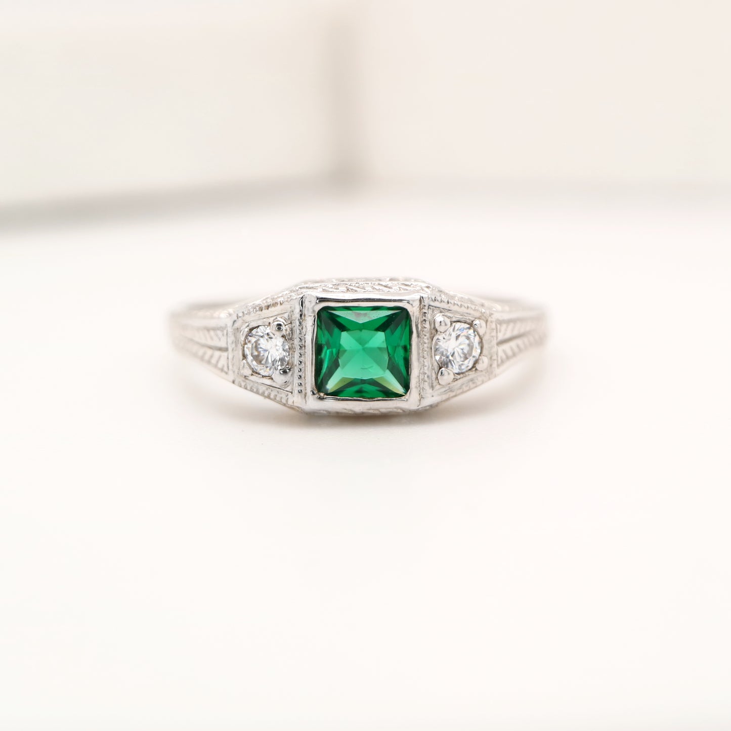 Art deco 9k white gold ring with center emerald and shoulder diamonds