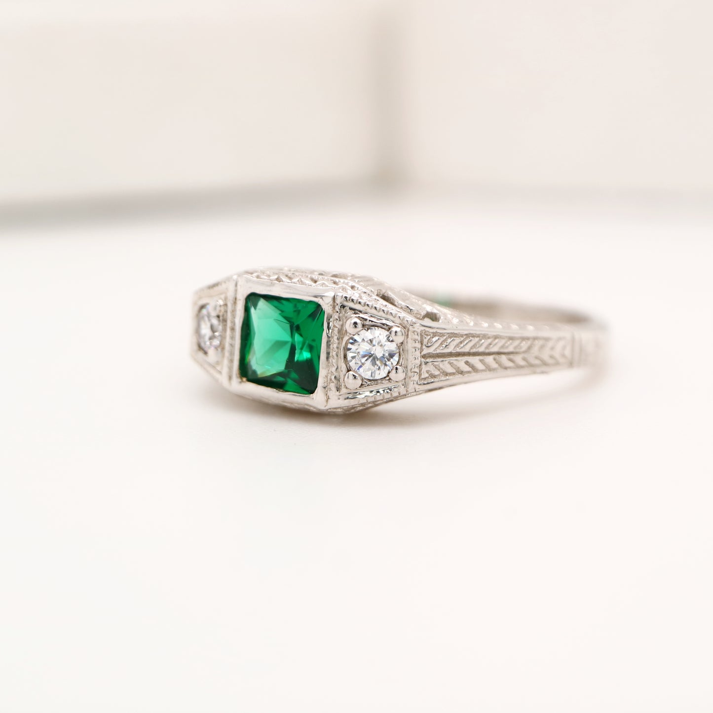 Art deco 9k white gold ring with center emerald and shoulder diamonds
