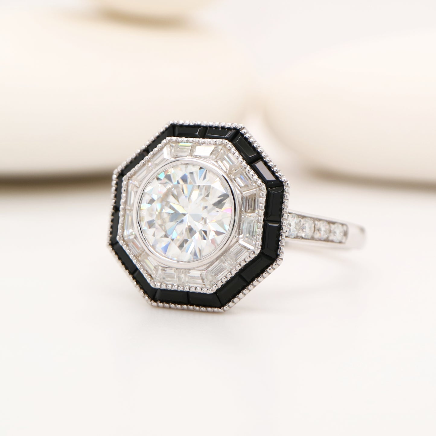 Moissanite target ring with moissanite and onyx halo in white gold